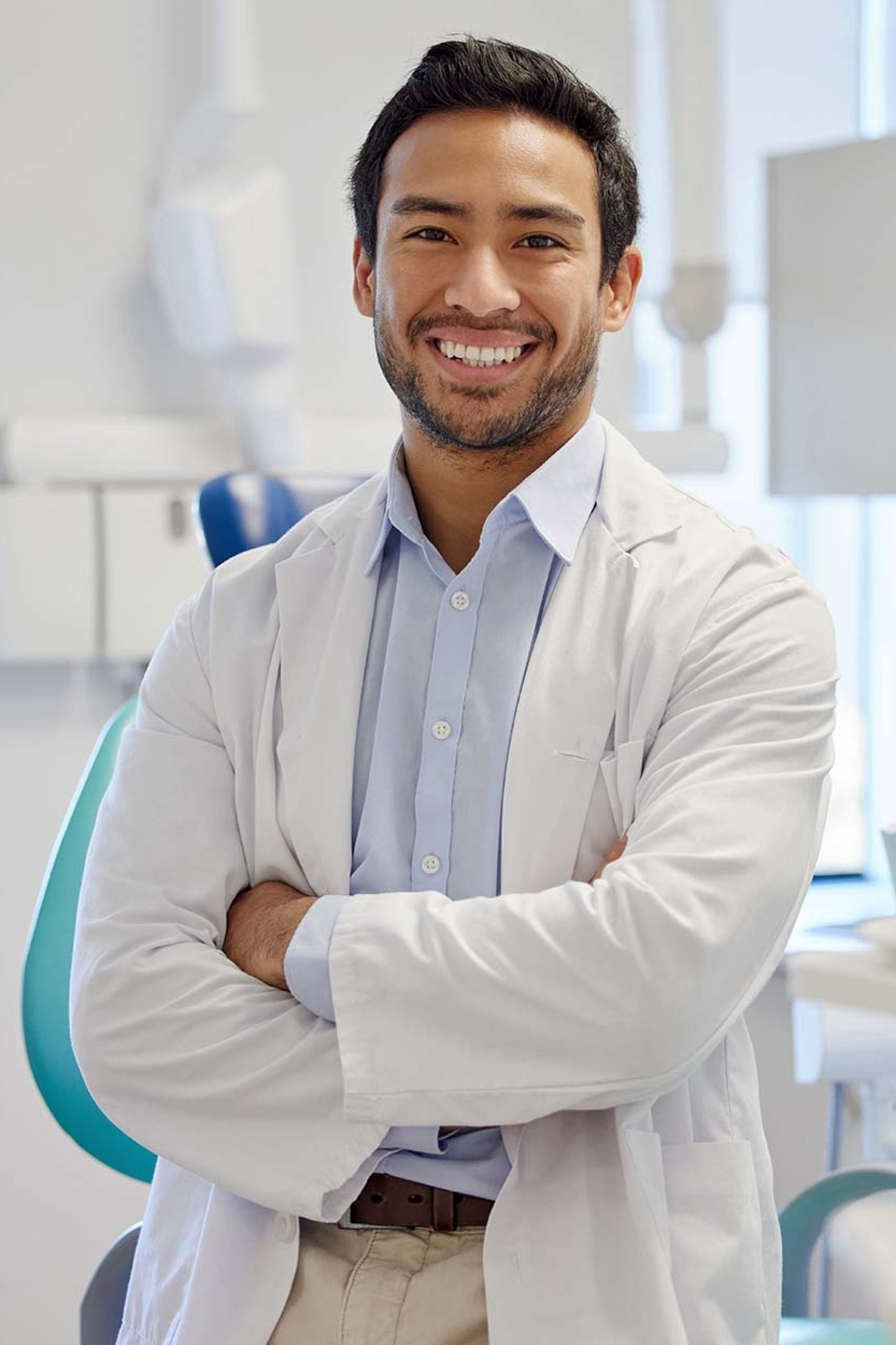 Portrait of confident a young dentist working in his consulting room.